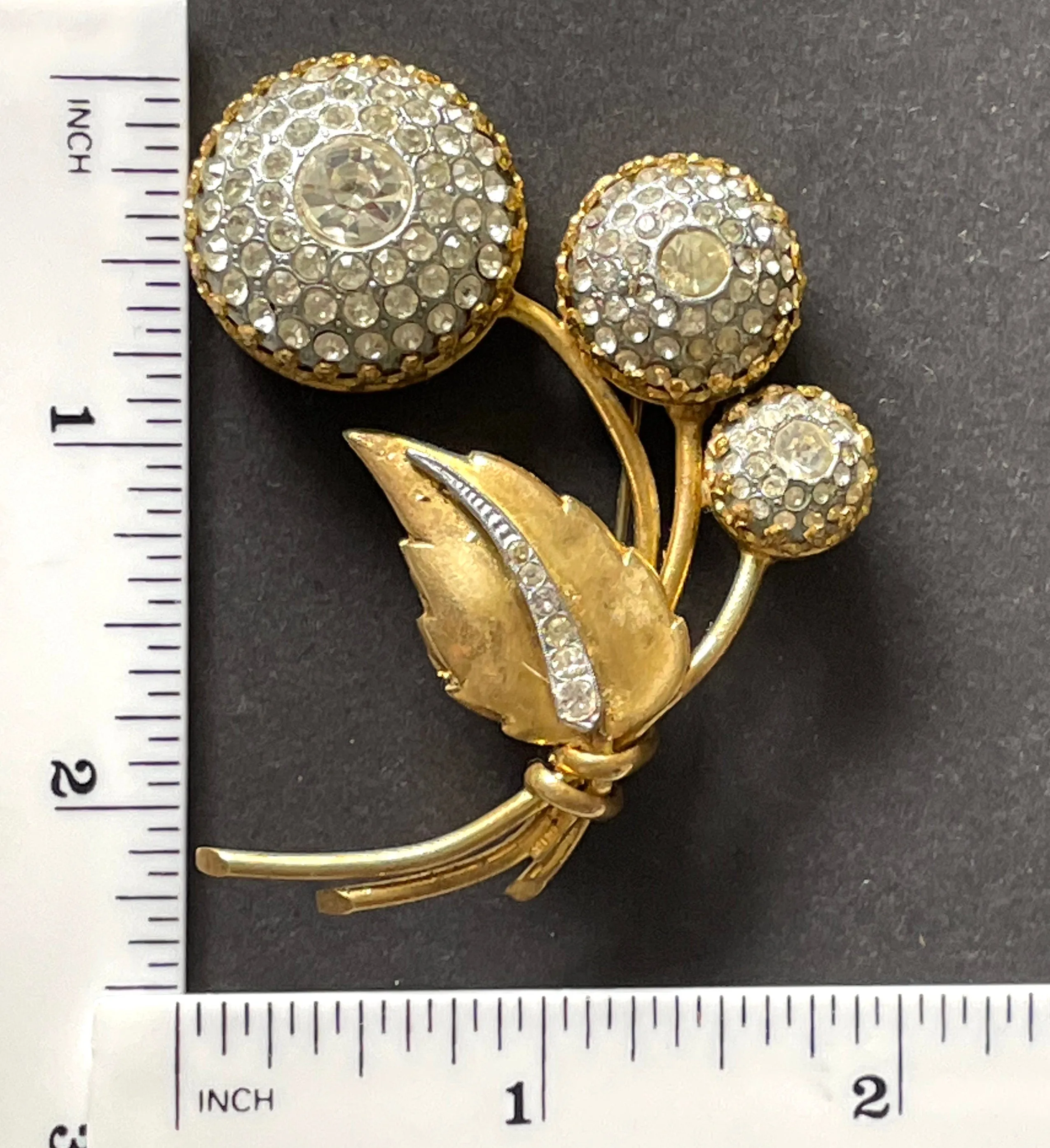 Large vintage Art Deco clear paste and gold tone floral brooch with unusual claw set rhinestone encrusted circular pieces