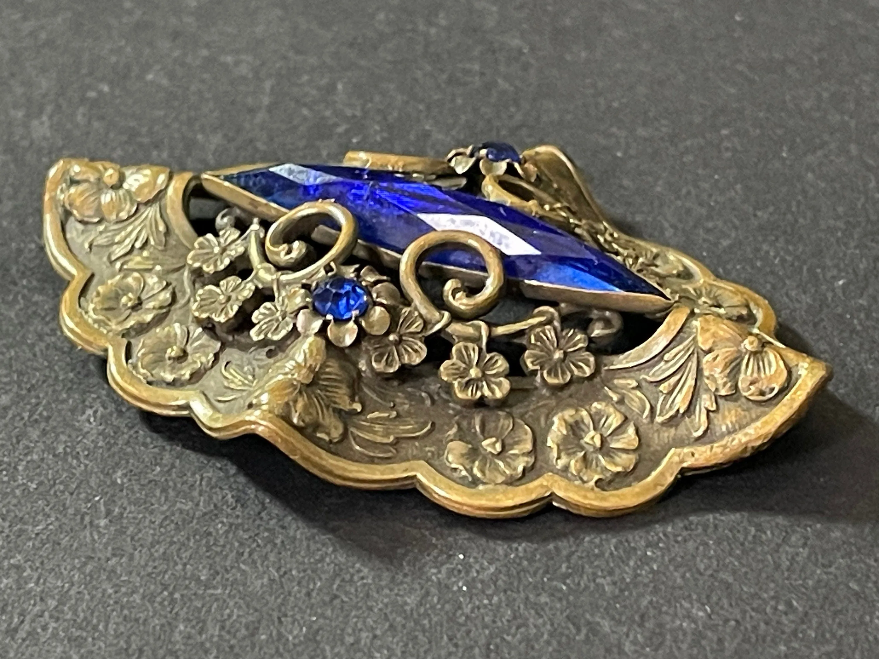 Large vintage Art Nouveau to Art Deco sapphire blue rhinestone & ornate gold tone three dimensional floral design Czech brooch, Neiger style